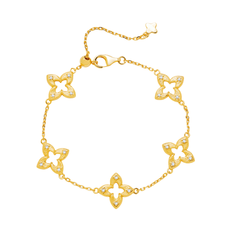 Bracelet doré en titane avec cinq motifs trèfle ajourés et éclats de zircon, chaîne fine plaquée or, fermoir mousqueton.