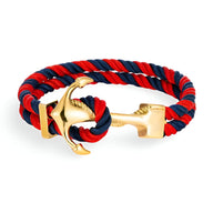 Bracelet double cordon bleu et rouge avec motif ancre dorée en métal brillant.