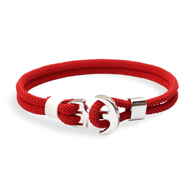 Bracelet double cordon rouge avec motif ancre large en métal argenté.