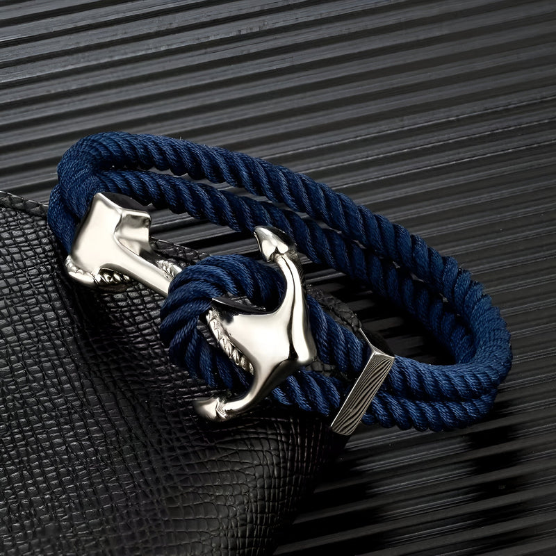Bracelet double cordon bleu marine avec motif ancre argenté et fermoir élégant.