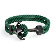 Bracelet double cordon vert avec motif ancre noire en métal brillant, style marin.