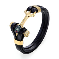 Bracelet homme double cordons noirs avec ancre marine dorée intégrant une boussole colorée.