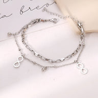 Bracelet double en acier inoxydable argenté avec charms infini et maillons variés, modèle Iloa.