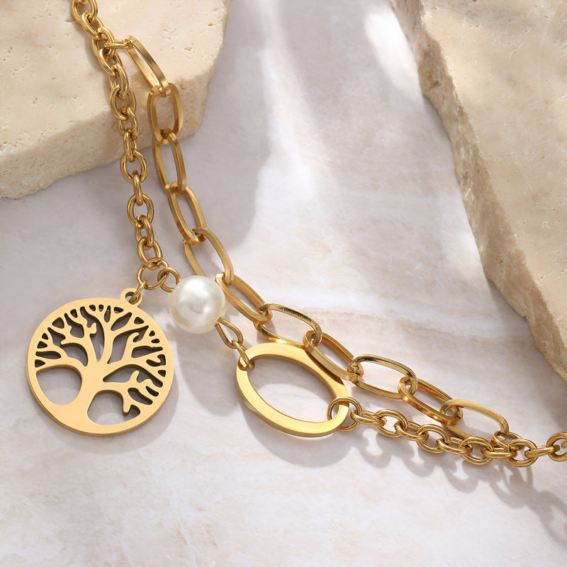 Bracelet double en acier inoxydable or avec pendentif arbre de vie mini et perle blanche.