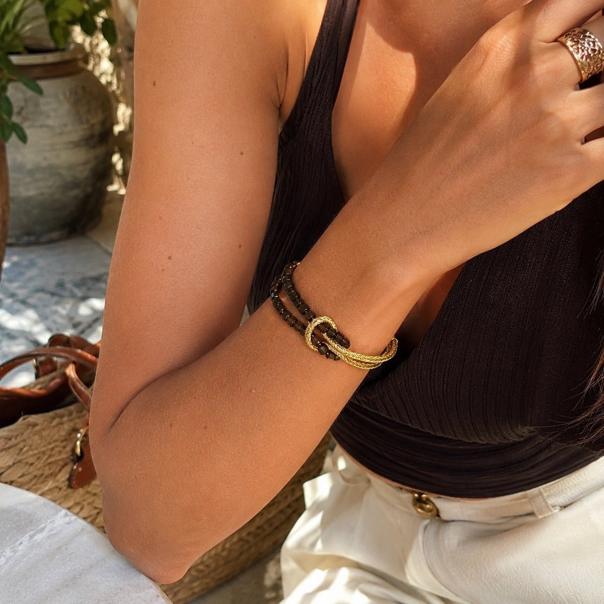 Double-strand bracelet with natural stones, twisted golden cord, central knot, Idecine model