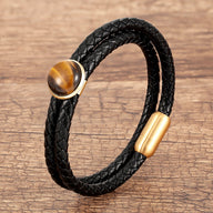 Bracelet double-rangs en microfibre noire tressée avec pierre oeil de tigre ronde et fermoir doré mat.