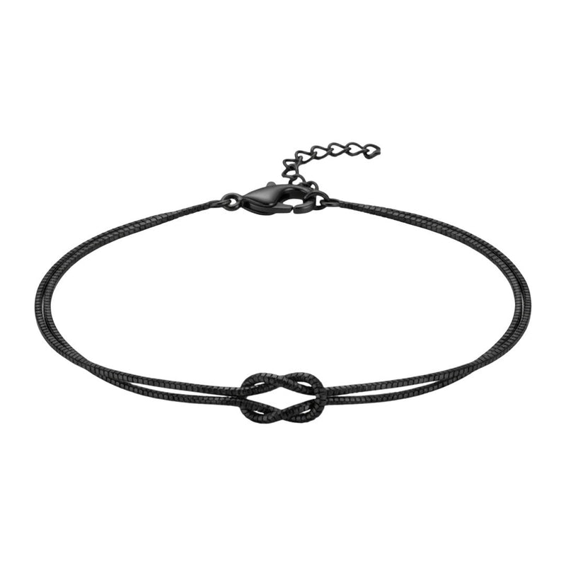 Bracelet fin en acier inoxydable noir avec nœud central et chaîne ajustable.