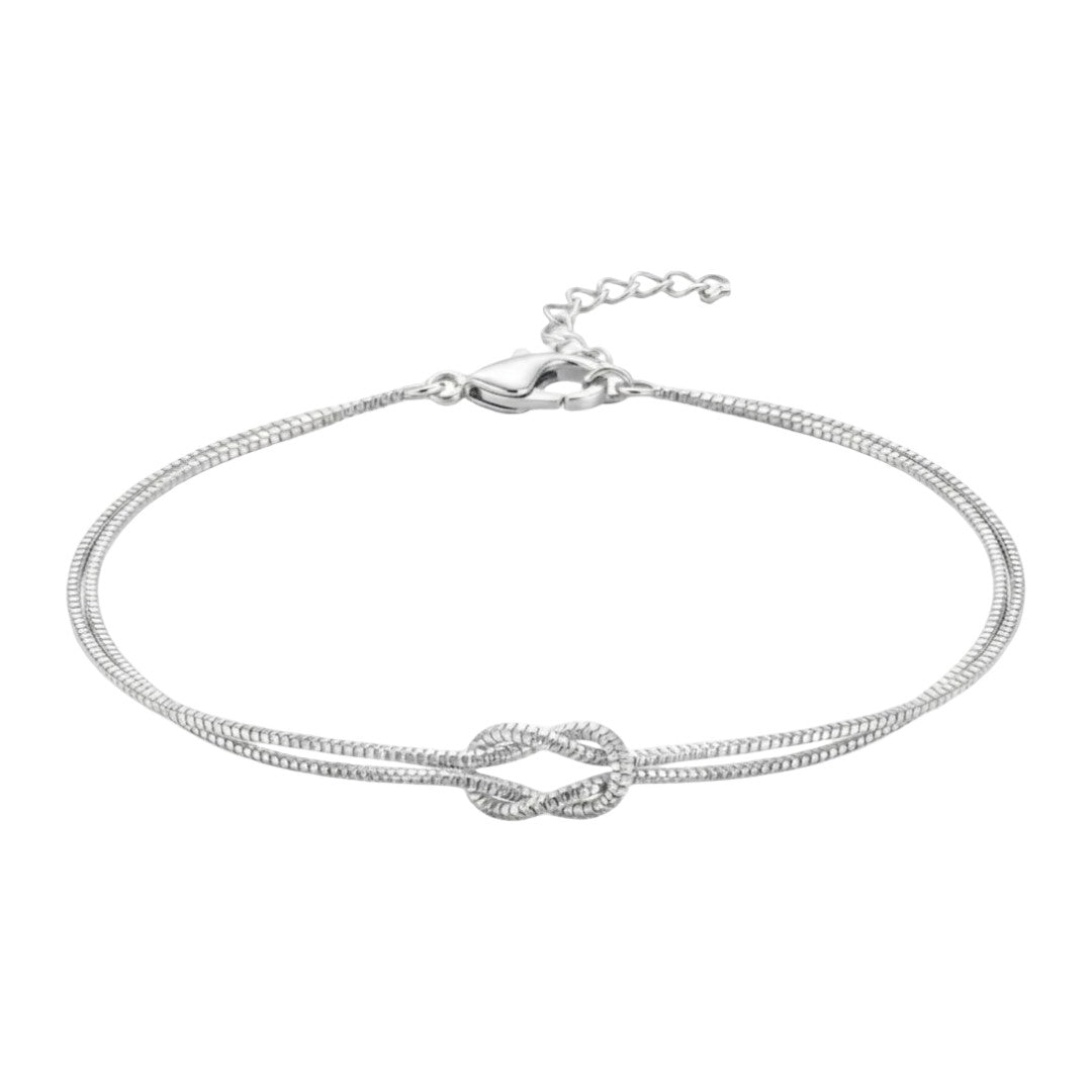 Bracelet fin en acier inoxydable argenté avec nœud central élégant, chaîne double délicate ajustable.