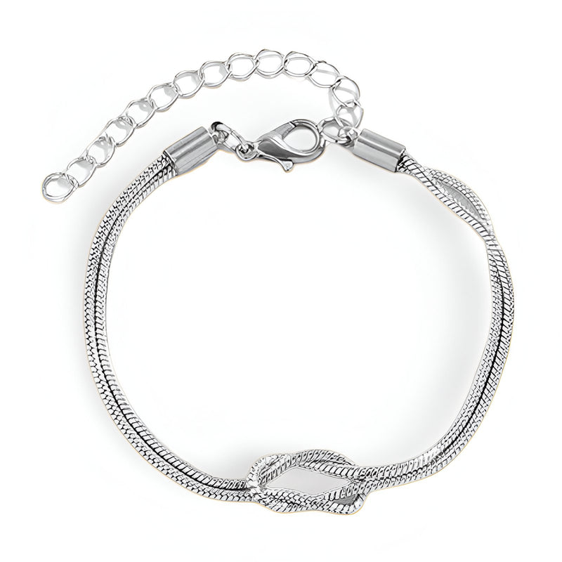Bracelet femme en acier inoxydable argenté avec nœud central et chaîne réglable.