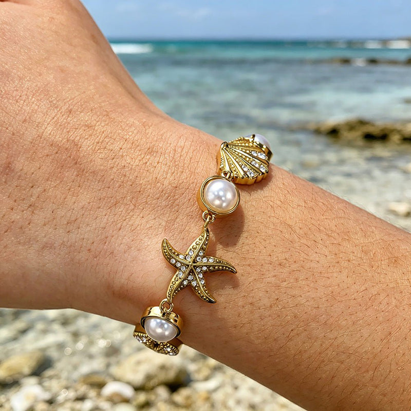 Pulsera de acero inoxidable dorado, perlas de agua dulce y dijes marinos, ajustable, modelo Ridèle