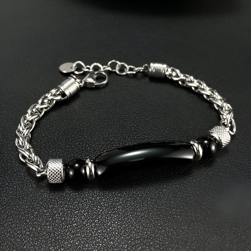 Bracelet homme en acier inoxydable argenté avec pierre d'œil de tigre noire allongée et détails texturés.