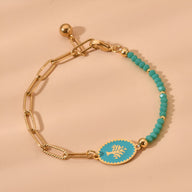 Bracelet femme en acier inoxydable, chaîne dorée et perles turquoise avec médaillon arbre de vie coloré.