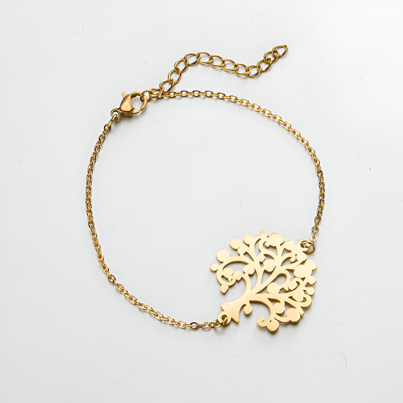 Bracelet chaîne fine en acier inoxydable doré avec pendentif arbre de vie ajouré.