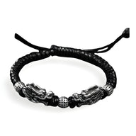 Bracelet homme en argent massif tressé noir avec double tête de dragon argentée et perles texturées.