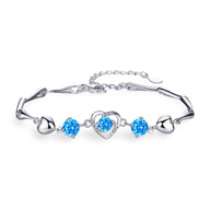 Bracelet en argent avec charmes cœur et cristaux bleus étincelants, modèle Stacy pour femme.