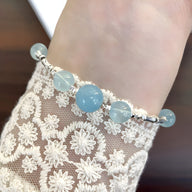 Bracelet en argent sterling avec pierres rondes d'aigue-marine bleu clair, style délicat et féminin.