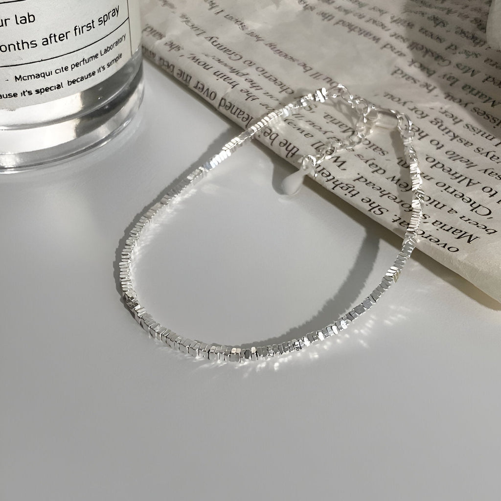 Bracelet fin en argent sterling avec maillons brillants, style élégant et épuré.