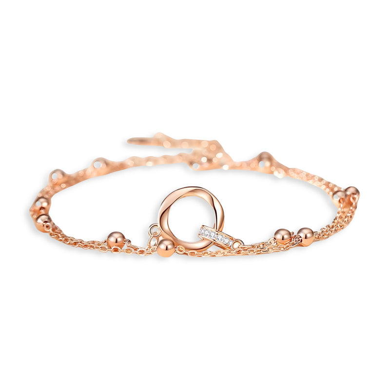 Bracelet en argent rosé pour femme avec maillons fins et anneau central lisse.