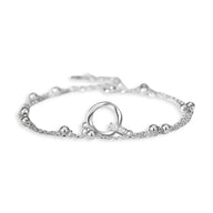 Bracelet fin en argent sterling avec anneau central lisse et petites perles sur chaîne délicate.