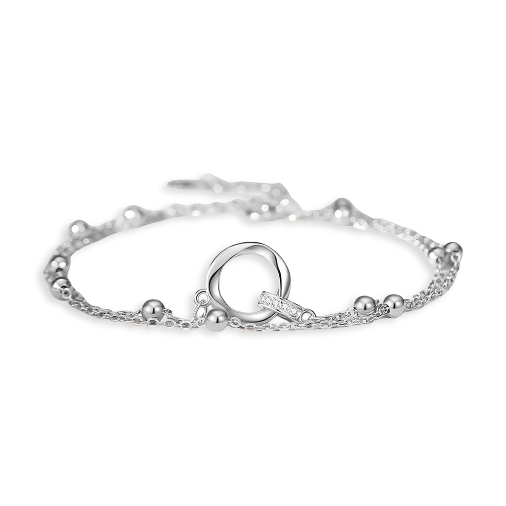 Bracelet fin en argent sterling avec anneau central lisse et petites perles sur chaîne délicate.