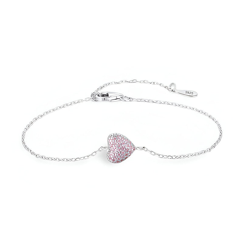 Bracelet en argent sterling avec chaînette fine et charm coeur orné de petites pierres roses.