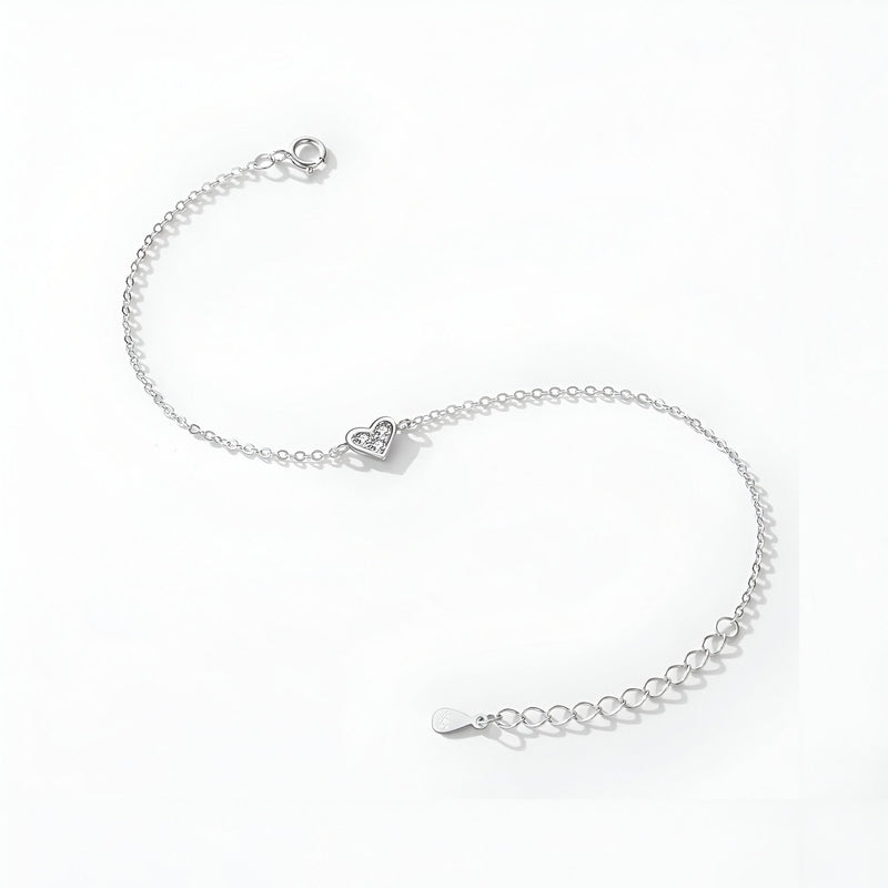 Bracelet fin en argent sterling avec pendentif cœur détaillé et chaîne ajustable.