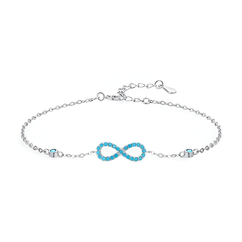 Bracelet en argent sterling avec charm infini orné de petites turquoises, design délicat pour femme.