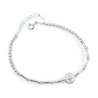 Bracelet fin en argent sterling avec chaîne à maillons et charm tulipe rose gravé.