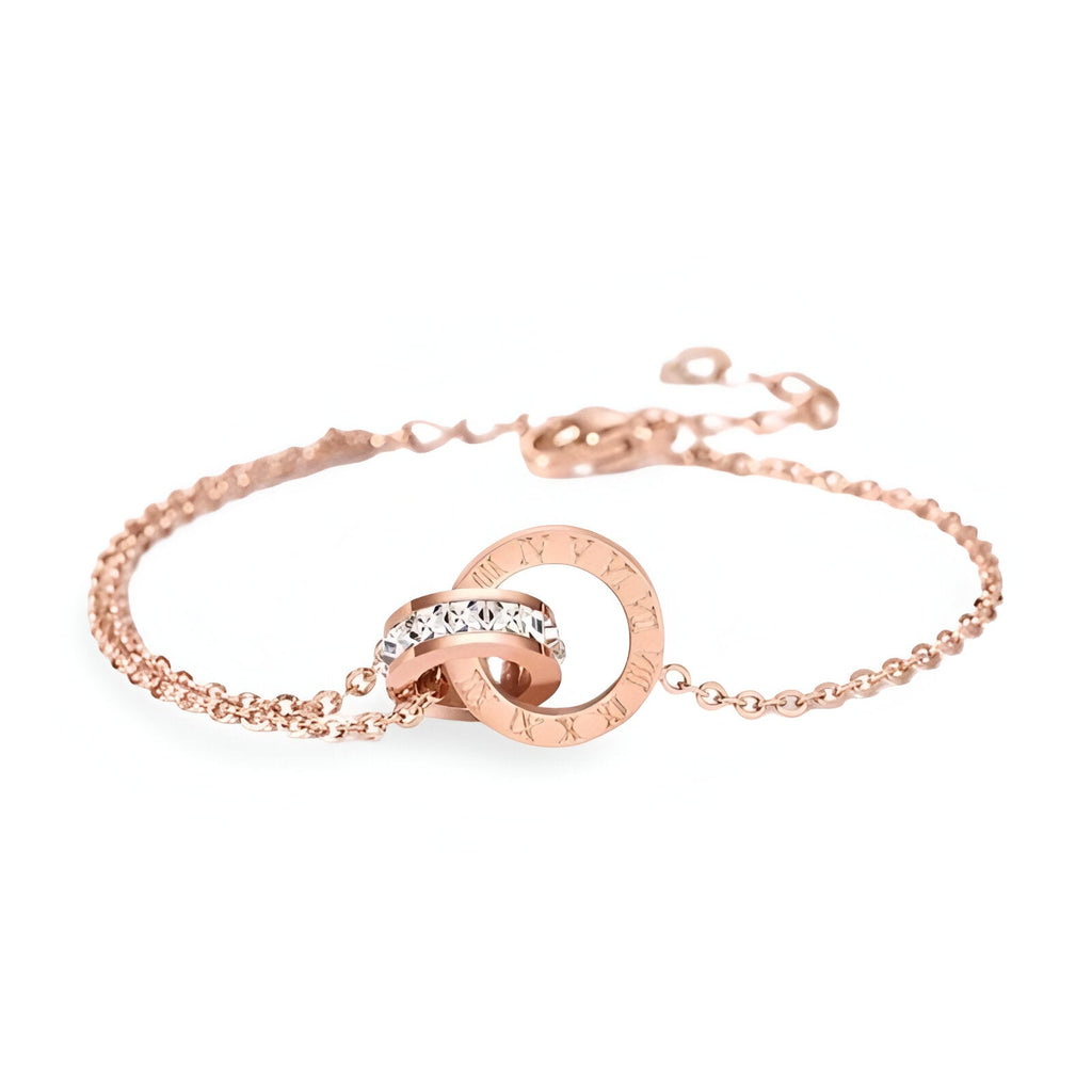 Bracelet femme en titane or rosé avec duo de cercles entrelacés et chiffres romains incrustés.