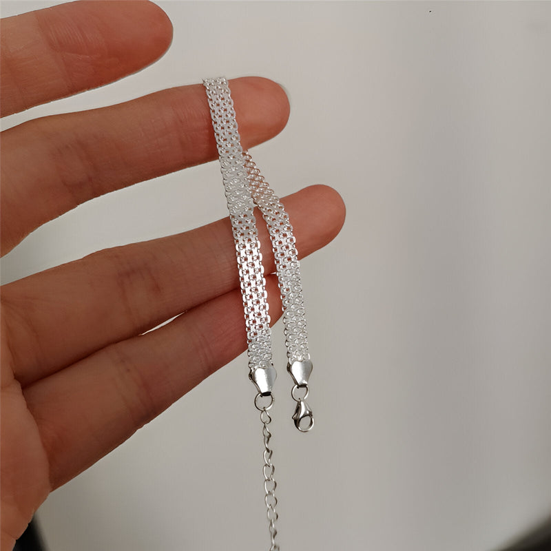 Bracelet en argent sterling tressé pour femme avec fermoirs mousqueton et chaîne d’extension.