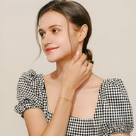 Bracelet en argent sterling fin avec motif feuille scintillante porté au poignet, style délicat et élégant.