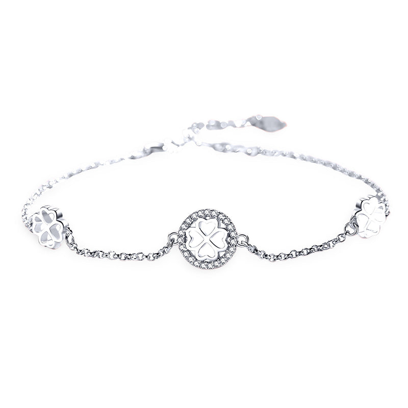 Bracelet fin en argent sterling avec pendentifs trèfle à quatre feuilles ajourés et chaîne délicate.