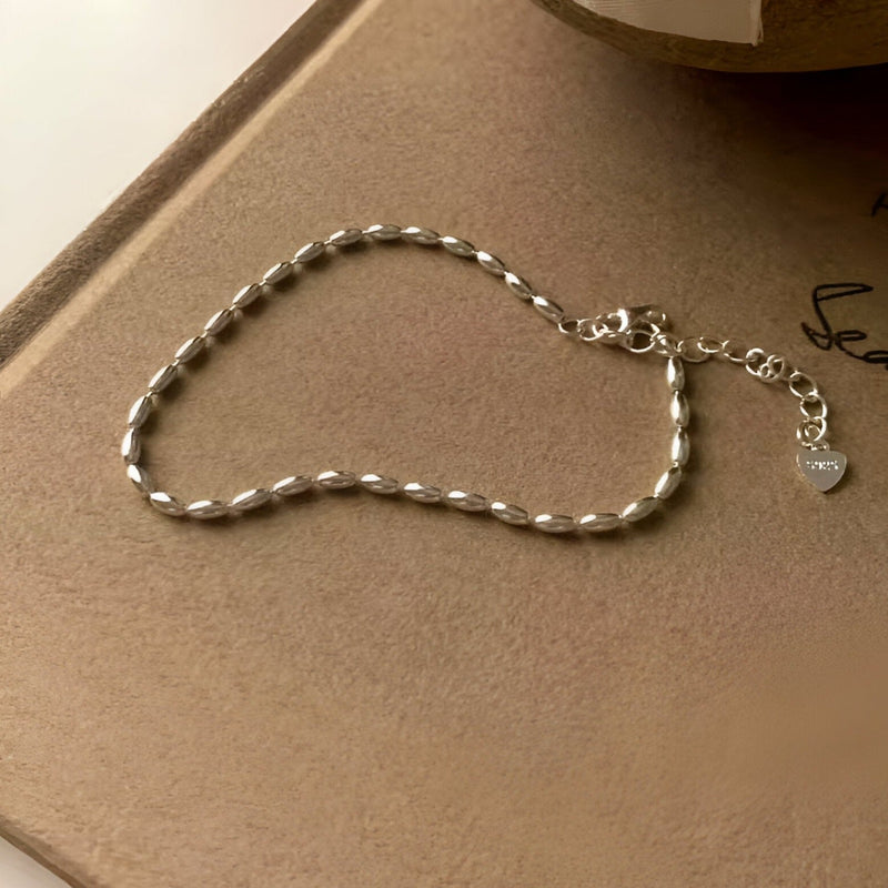 Bracelet en argent sterling style grain de riz avec chaîne réglable et pendentif cœur.