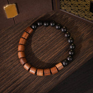 Bracelet unisexe en bois de palissandre marron et perles rondes en ébène noir sur fil élastique.