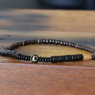 Bracelet mixte en perles de bois d’ébène noir et obsidienne brillante, design naturel et minimaliste.