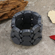 Bracelet large en bois naturel gris foncé, design original avec maillons ovales lisses.