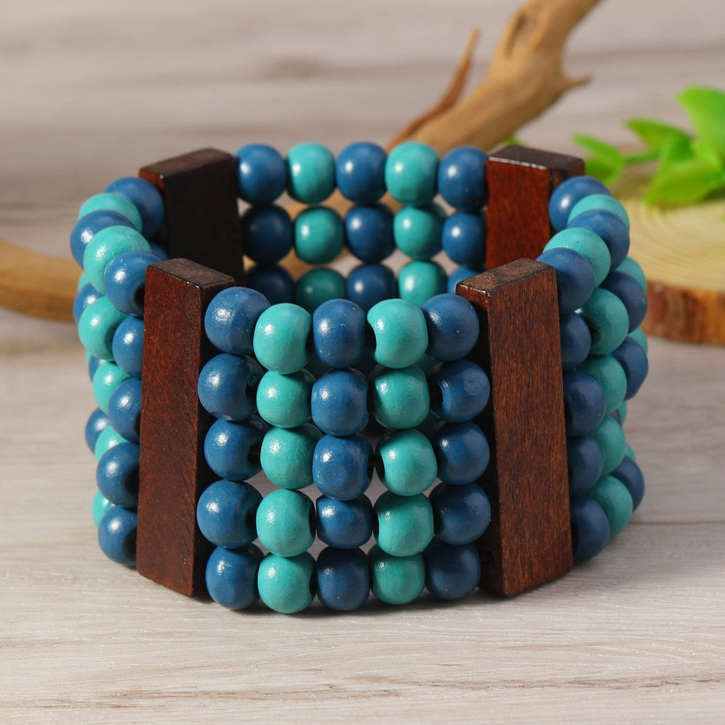 Bracelet manchette femme perles bois naturel bleu avec séparateurs en bois foncé.