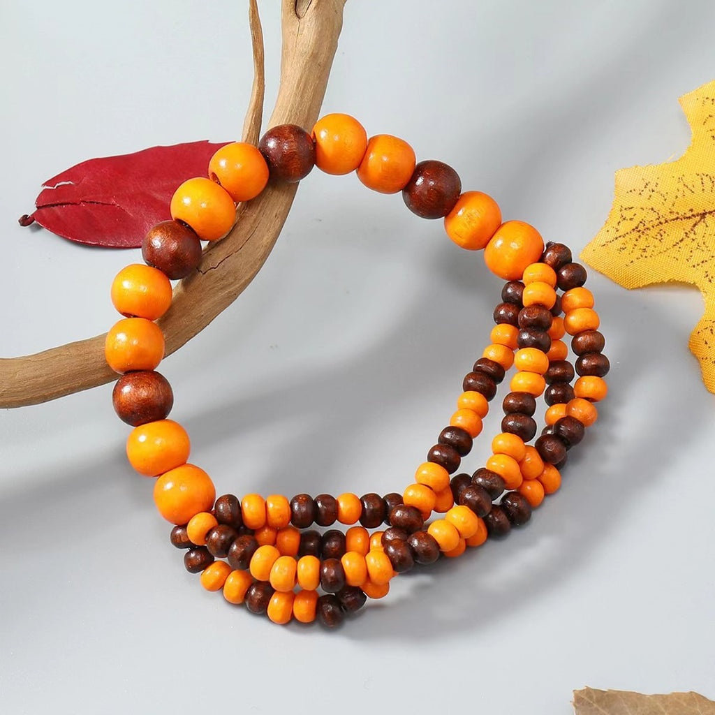 Bracelet femme en perles boisées orange et marron, style naturel, modèle Iglesias.
