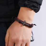 Bracelet en cuir marron avec croix chrétienne en métal, style tressé pour homme.