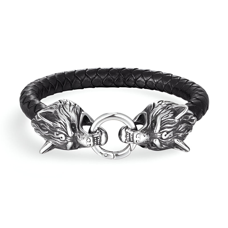 Bracelet en cuir noir tressé avec double tête de loup en métal argenté et fermeture anneau.