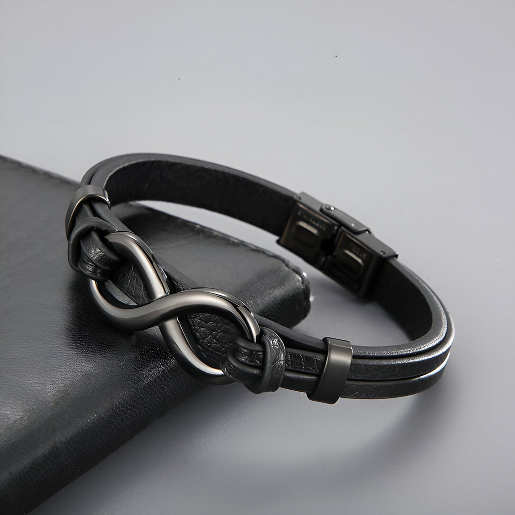 Bracelet noir en cuir avec motif infini en acier inoxydable, fermoir métallique noir mat.