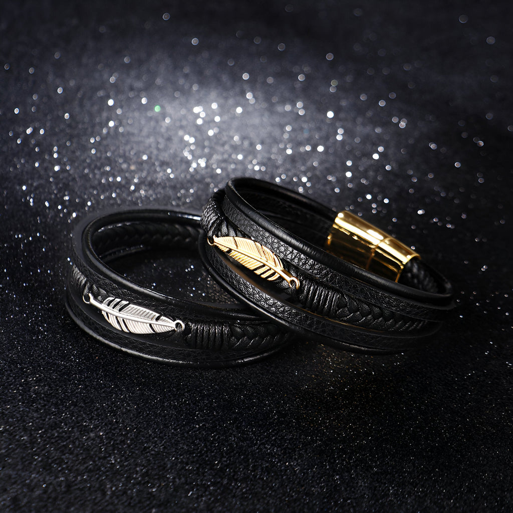 Bracelet en cuir noir multi-rangs avec motif plume en métal doré et argenté, fermeture magnétique.
