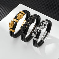 Bracelet en cuir noir tressé avec ornement double têtes de mort en métal or, noir et argent.
