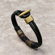 Bracelet homme cuir noir double tour avec éléments dorés et détails tressés style égyptien Horus.