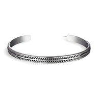 Bracelet ouvert en cuivre plaqué argent avec motif chevrons gravés, style épuré et masculin.