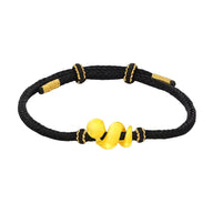 Bracelet noir en fil ciré avec serpent doré enroulé au centre, style moderne et élégant.