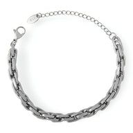 Bracelet en maille épaisse en titane argenté avec fermoir à mousqueton et chaîne ajustable.