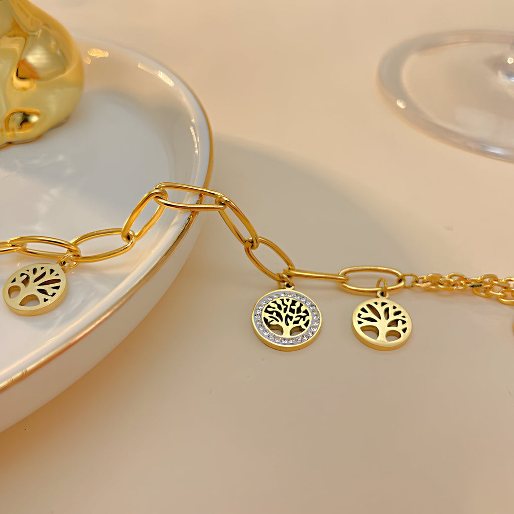 Bracelet en maille épaisse doré avec pendentifs arbre de vie en acier inoxydable.