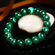 Bracelet mixte en boules de malachite verte aux motifs naturels, finition polie brillante.