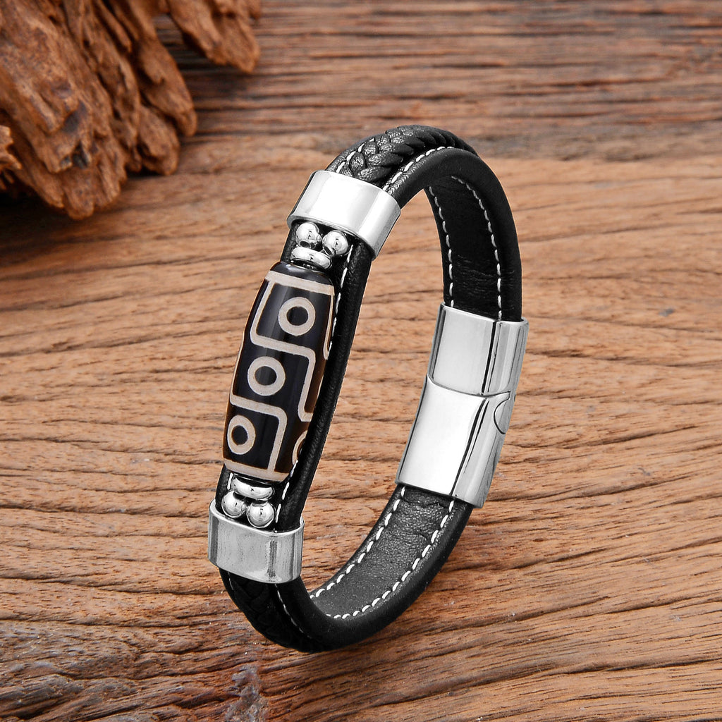 Bracelet homme en microfibre noir avec motif tibétain en argent et fermoir métallique brillant.